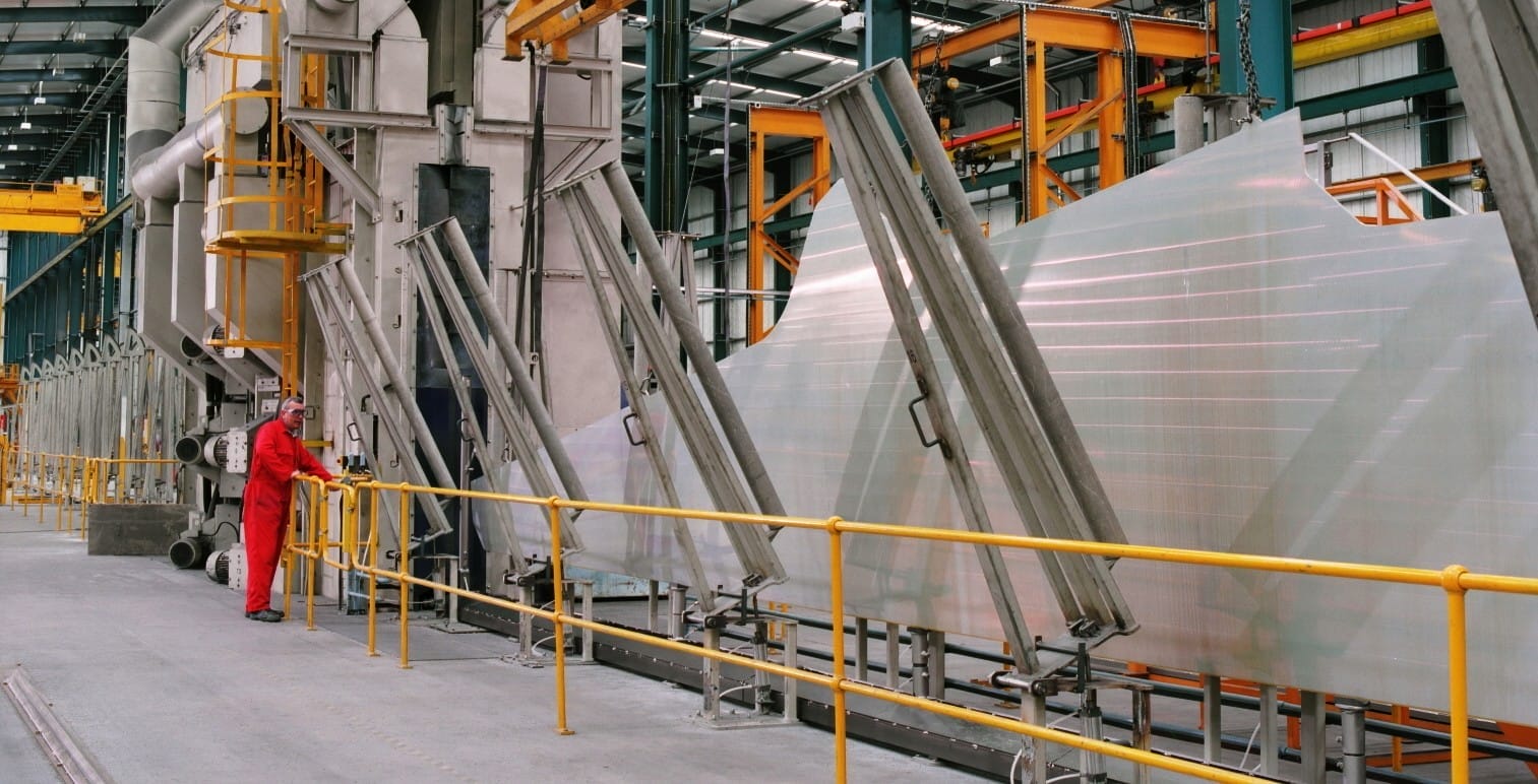 Shot peen forming wing skin